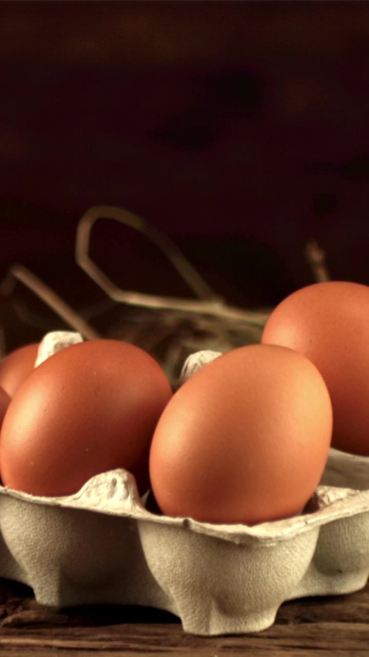 Close-up of Fresh Brown Eggs in Carton on Rustic Wooden Table