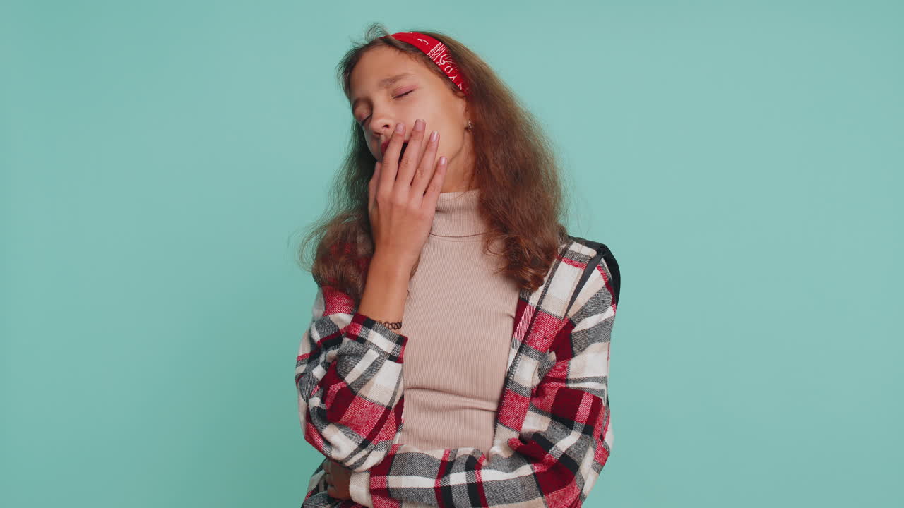 Tired sleepy child girl yawning, feeling somnolent lazy bored, gaping suffering from lack of sleep