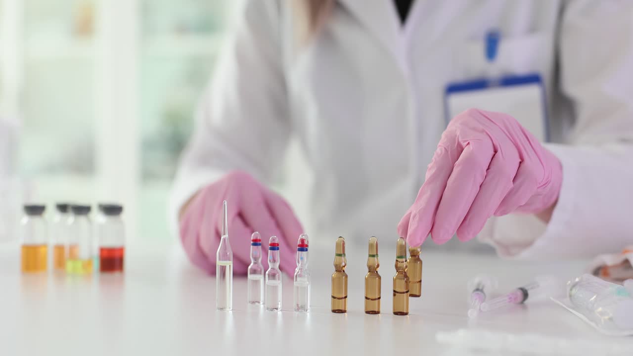 Medical Professional Handling Ampoules and Vials in a Laboratory