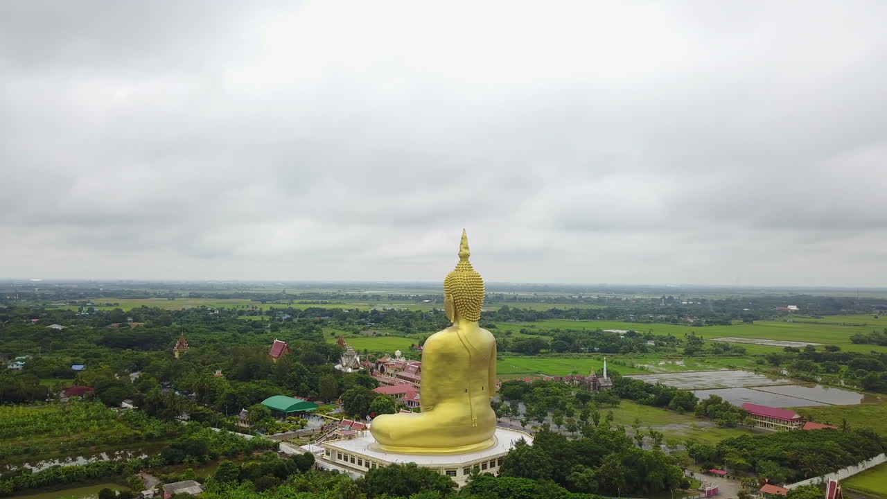 Aerial view of Wat Muang Buddha statue with serene landscape in Thailand
