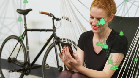 animation of connected icons globes, laughing caucasian woman scrolling cellphone