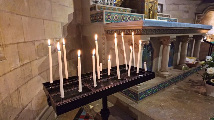 Close-up view about a few candles near the altar in L'Abbaye-aux-Hommes, Caen, France