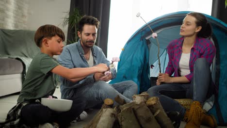 Handheld-video-of-family-camping-indoors
