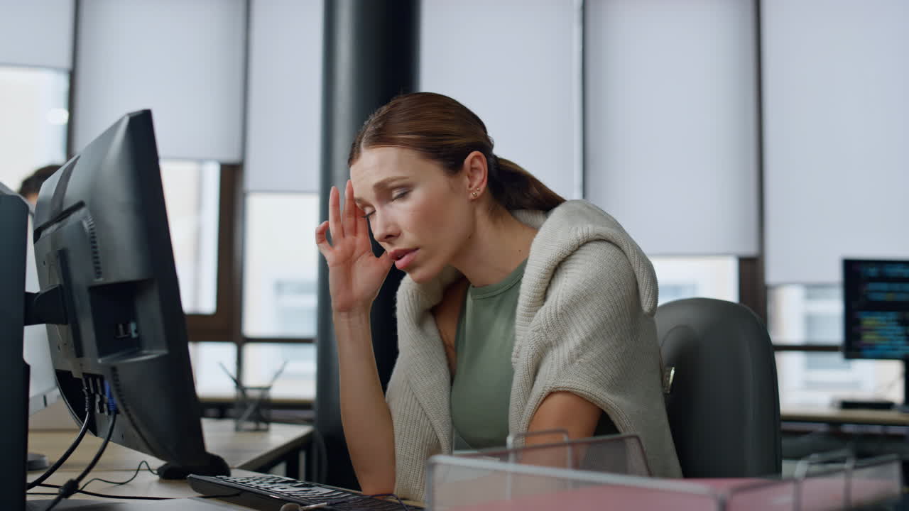 Tired employee working computer in office. Overwhelmed woman analyzing sales