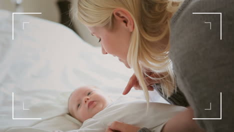 animation of frame over caucasian mother talking to baby