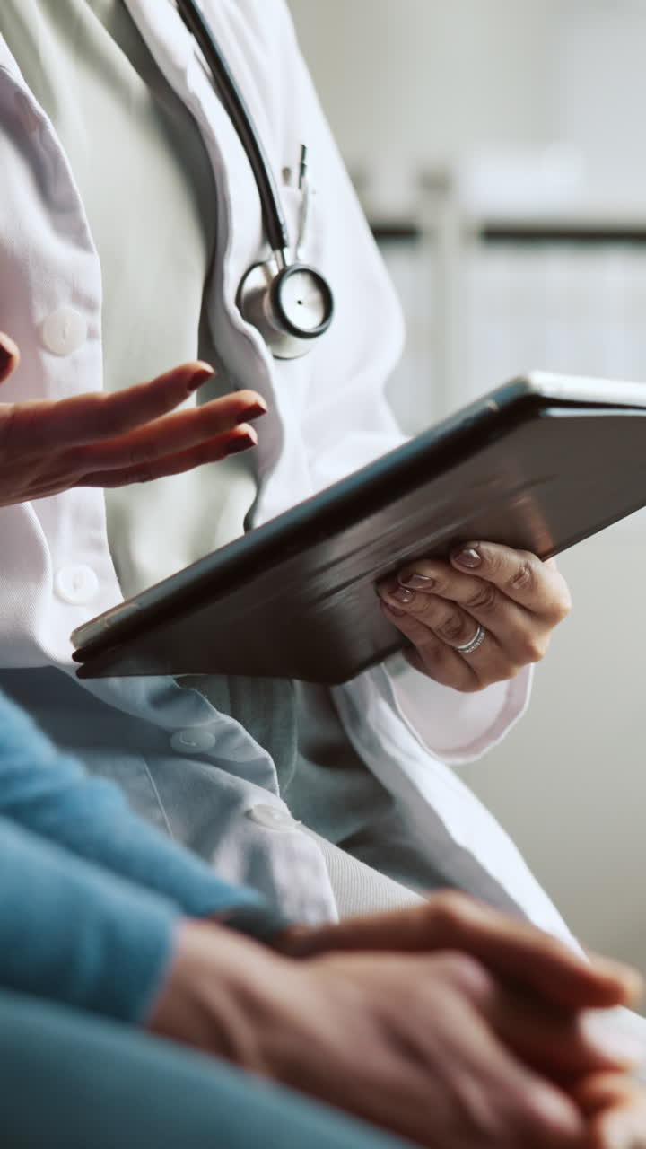 Doctor Explaining Medical Information to Patient Using a Tablet