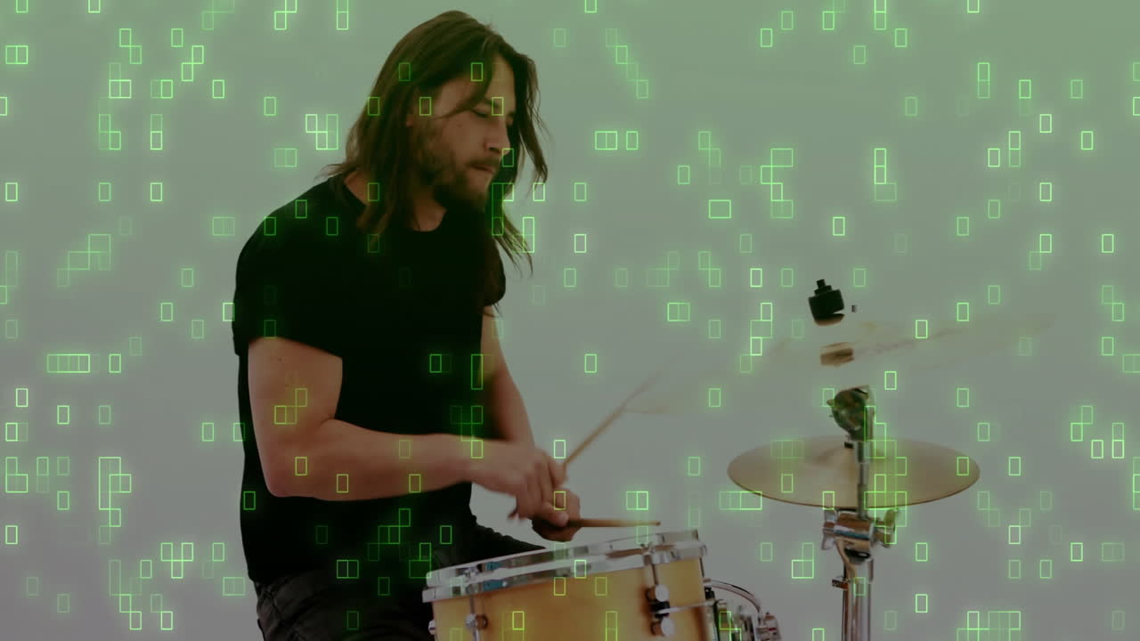 Male drummer playing snare drum and cymbal in music tech studio, showcasing green data blocks