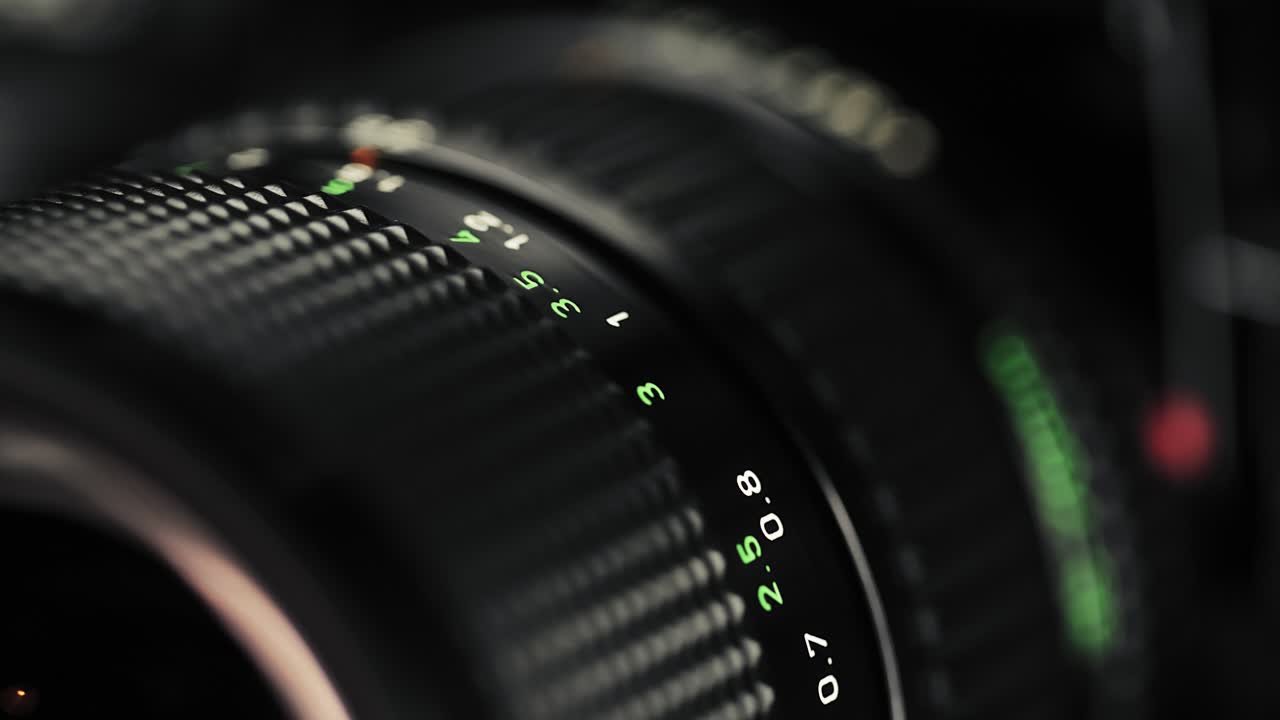 Close-up focus pull on a classic vintage zoom lens, showcasing engraved markings and smooth mechanics