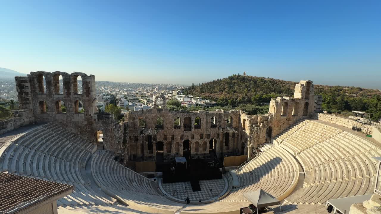 The Odeon of Herodes Atticus in Athens shines under bright blue summer skies.