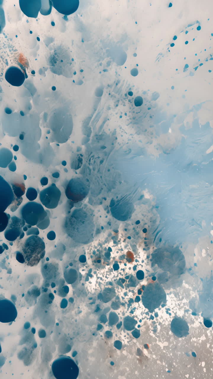 Abstract blue and white ink drops creating artistic patterns in water