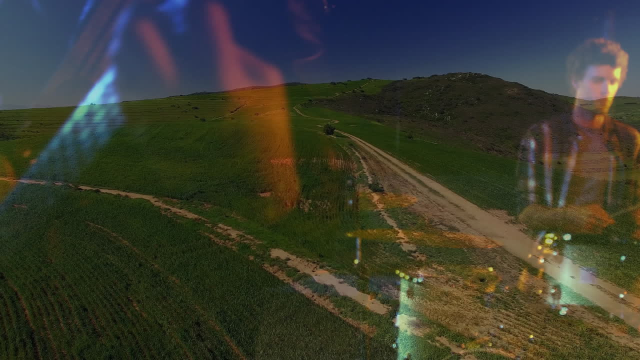 Male musician playing guitar overlaying farmland, with glowing lights enhancing music marketing