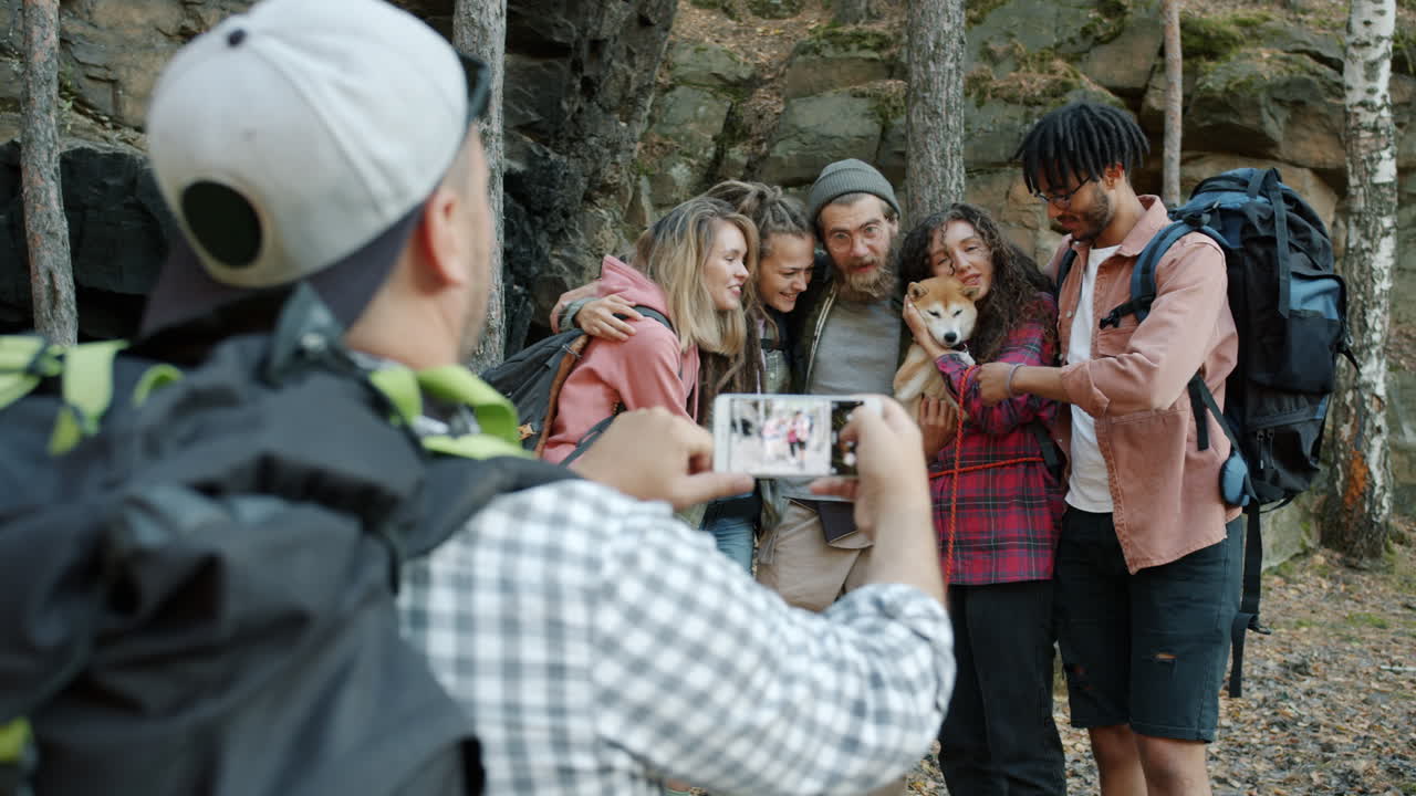 Group of Friends Hiking and Taking Pictures with Dog