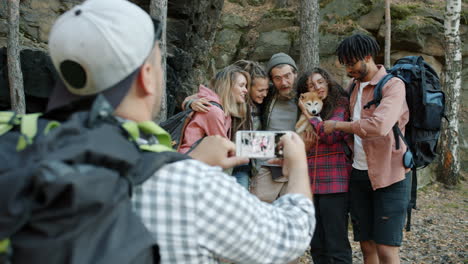 group of friends hiking and taking pictures with dog