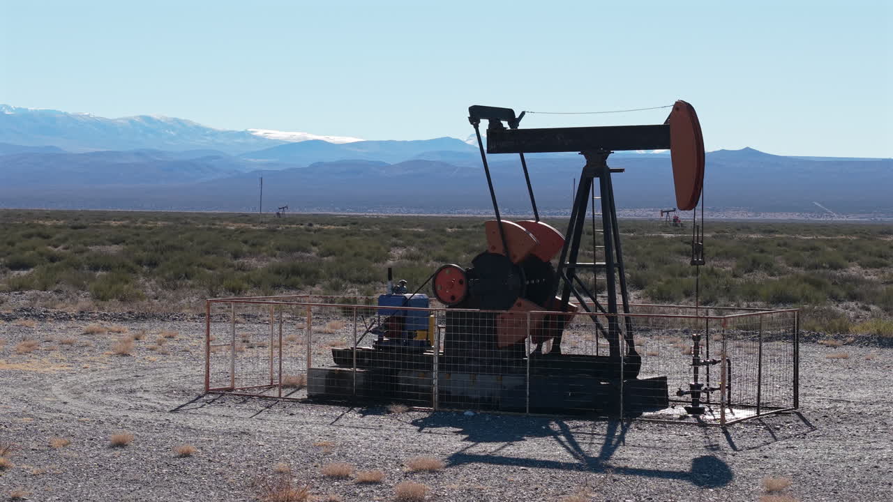 Aerial view of Industrial pumpjack operating in Patagonia, Crude oil machinery in Argentina
