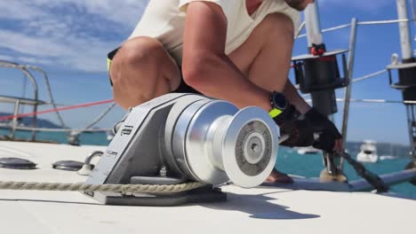 sailor working on boat winch