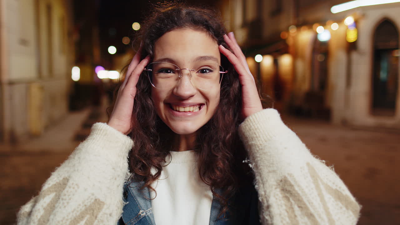 Happy teenager girl looking surprised at camera with big open eyes shocked by sudden victory win wow