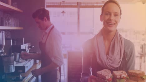 Animation-of-light-spot-over-smiling-caucasian-female-worker-with-sandwiches-and-colleague-in-cafe