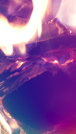 a close up of flames in log fire burning in a fireplace in vertical