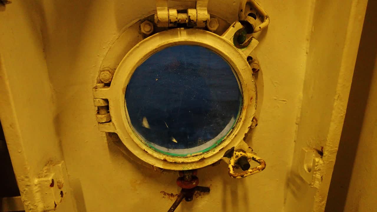 Looking out of a metal Ship porthole from inside