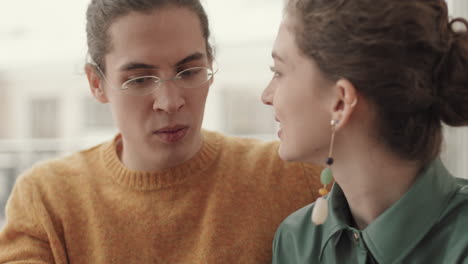 young man and woman having chat in cafe