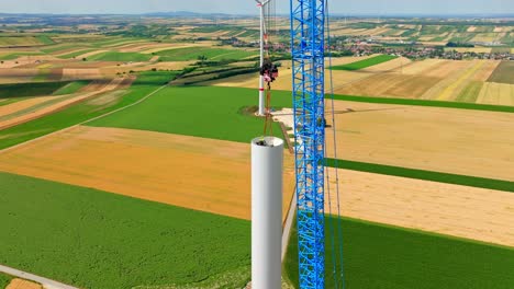 Engineer-Inside-Wind-Turbine-Tower-During-Assembly-Assisted-By-Crawling-Crane