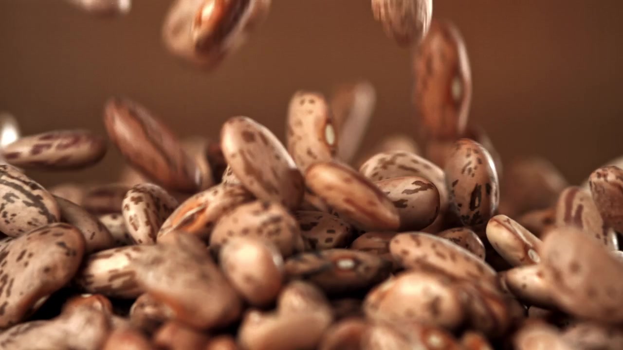 Dry Pinto Beans Falling and Piling Up in Slow Motion
