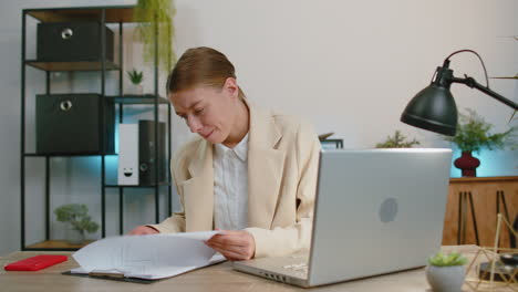 Stressed-business-woman-worried-about-financial-paperwork-problem-money-debt-budget-loss-at-office