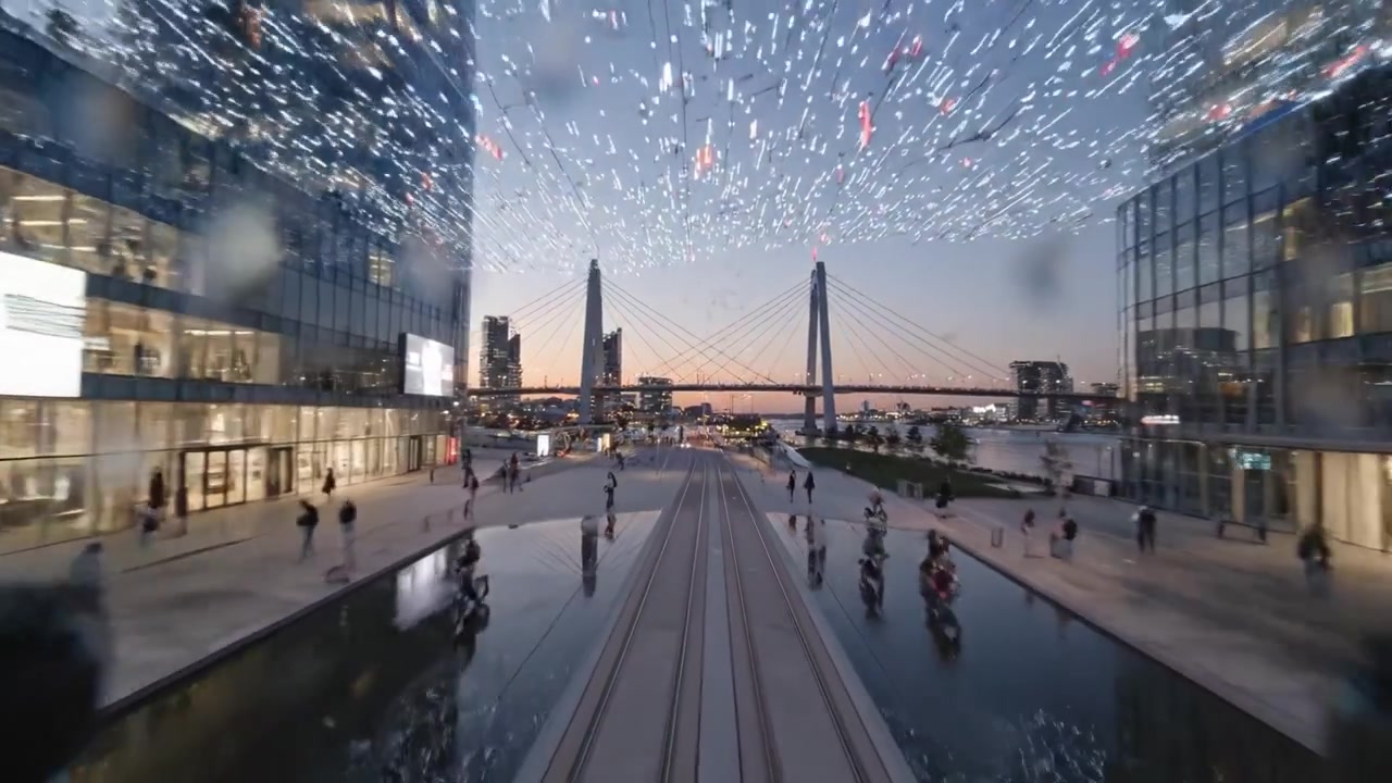 Scenic Cityscape Transition at Dusk: Vibrant Urban Life and Illuminated Modern Architecture Framed by a Beautiful Bridge Overlooking a Serene Waterway
