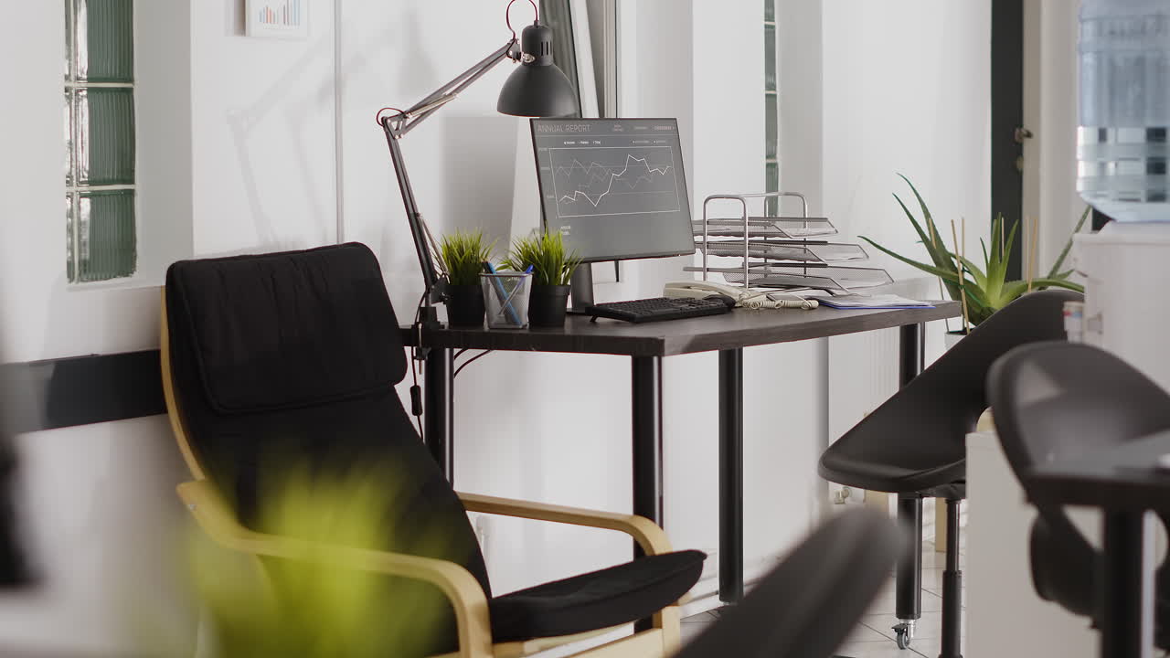 Office workspace with computer, desk, and chairs