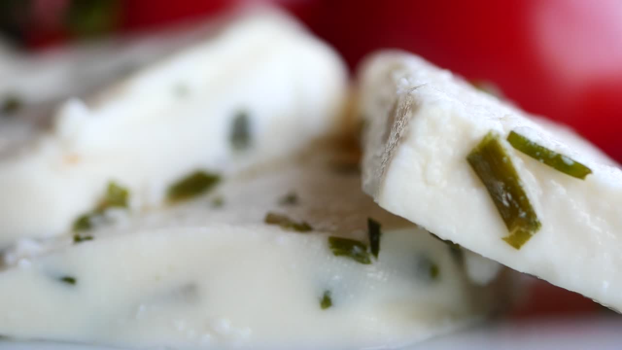 rebanadas de queso blanco con hierbas y tomates