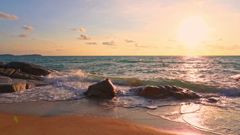 ocean waves crashing on rocky beach during sunset