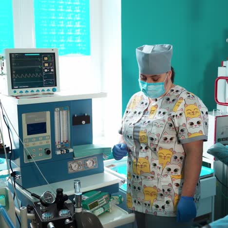 nurse in the intensive care room. modern medical equipment in clinic. doctor in mask near the monitor screen in intensive care unit. reanimation concept.