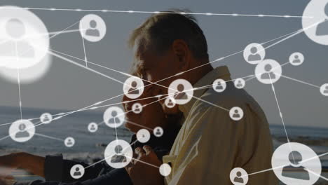 Network of connections animation over elderly couple walking by sea