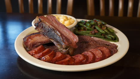 Traditional-Texas-barbecue-plate-with-pork-ribs,-smoked-sausage,-moist-brisket,seasoned-green-beans-and-creamy-macaroni-and-cheese,-slider-4K