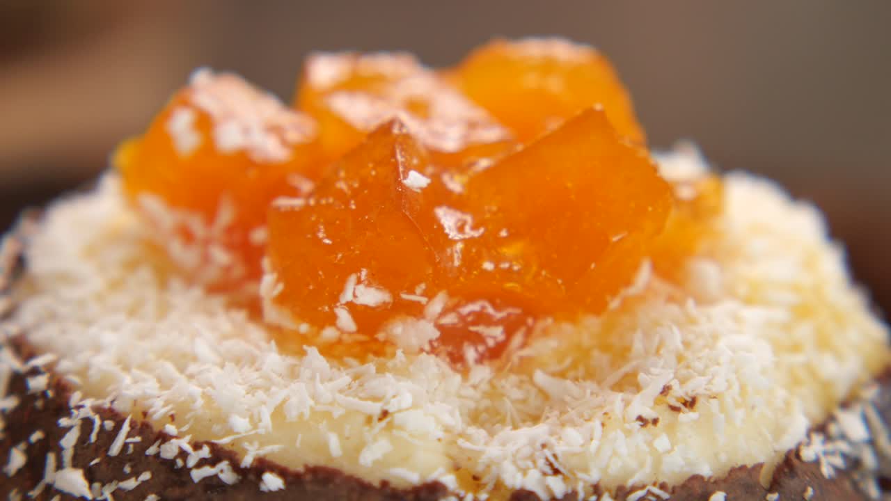 Delicious cupcake with orange topping and coconut flakes