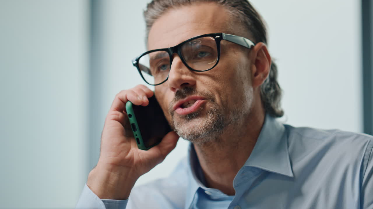 Nervous businessman arguing cellphone indoors portrait. Angry director yelling