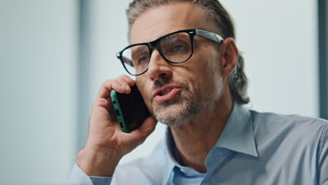 nervous businessman arguing cellphone indoors portrait. angry director yelling