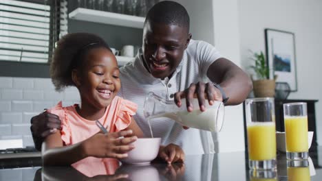 Video-of-african-american-father-and-daughter-eating-breakfast