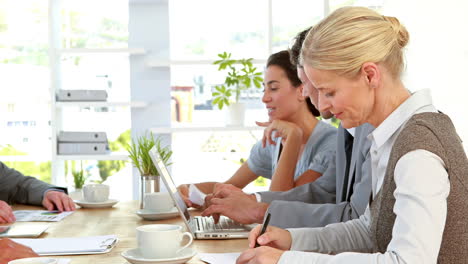 Business-people-working-on-laptop-computer-during-meeting