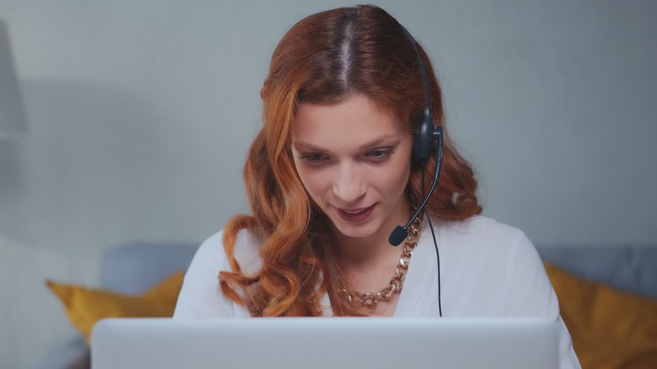 Caucasian woman office worker with wired headset making video call in laptop