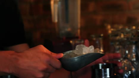 Bartender-preparing-cocktail-at-counter