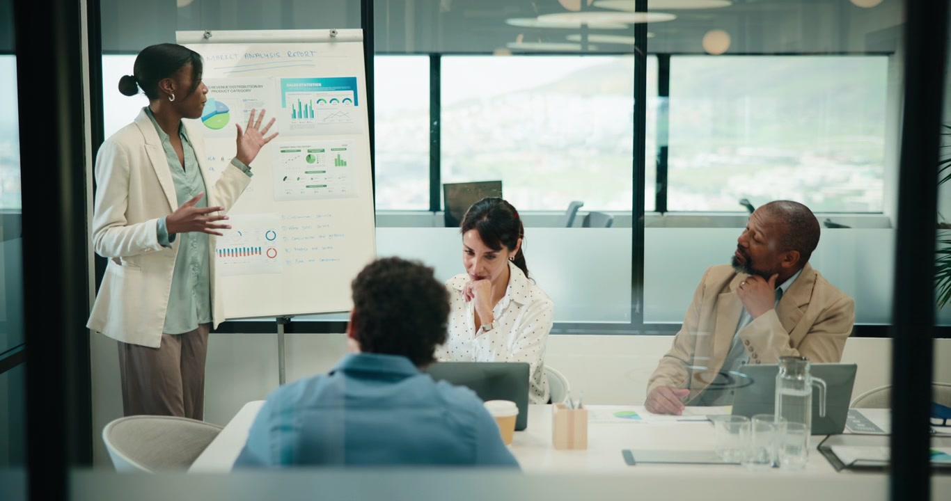 Businesswoman Presenting Data to Colleagues in Modern Office Meeting