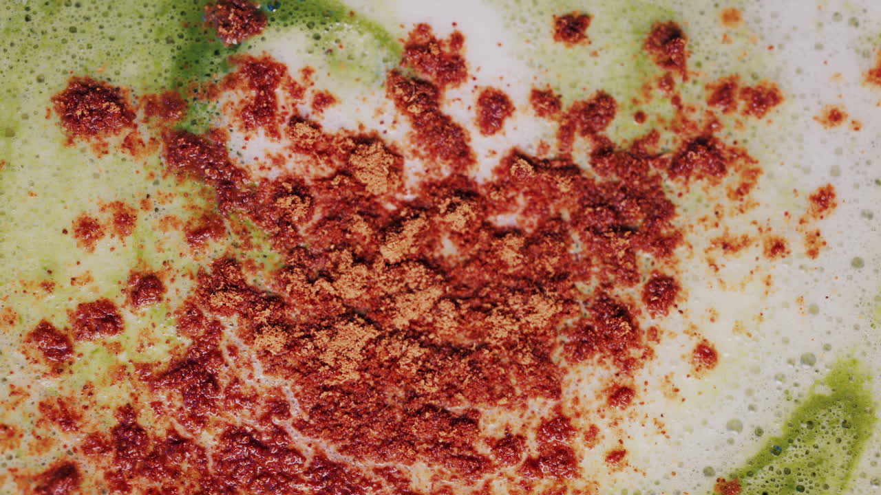 Close up of matcha a latte with cinnamon sprinkled on the foam