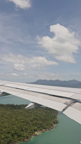view from a plane window of the sky with the wing shot in vertical