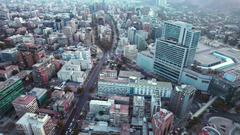 slow aerial orbit overhead los leones, metro station within downtown santiago