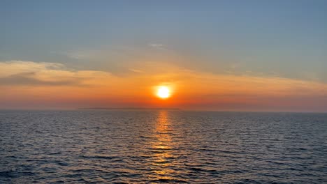 sunset over calm misty ocean