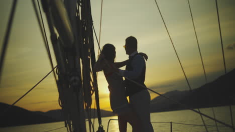 couple enjoying a romantic sunset on a sailboat