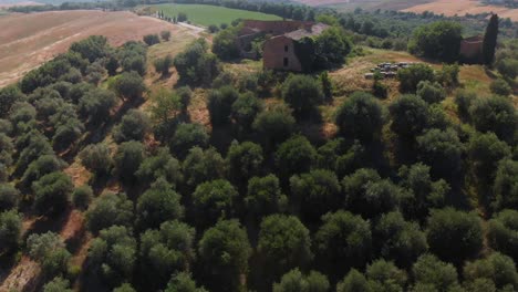 Aerial-circle-around-ruined-Tuscanian-mansion-near-San-Quirico-di-Orcia-Italy