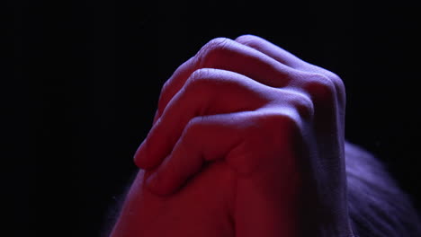 hands clasped together strong rubbing one another in anger and nervousness