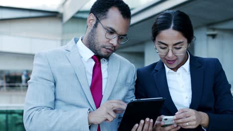 Compañeros-De-Trabajo-Enfocados-Con-Dispositivos-Digitales